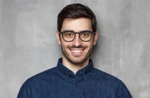 Number 1: Man with glasses and a smile wearing a denim shirt, representing the original photo used for video avatar generation.